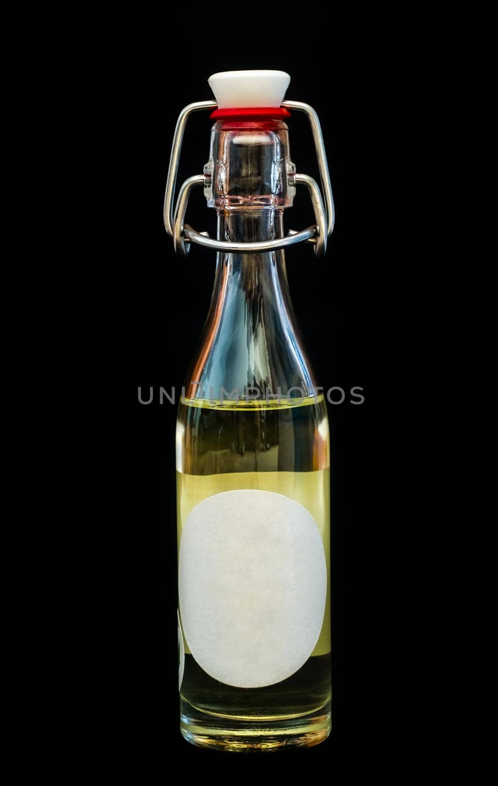 a bottle of oil with a blank label by Roberto