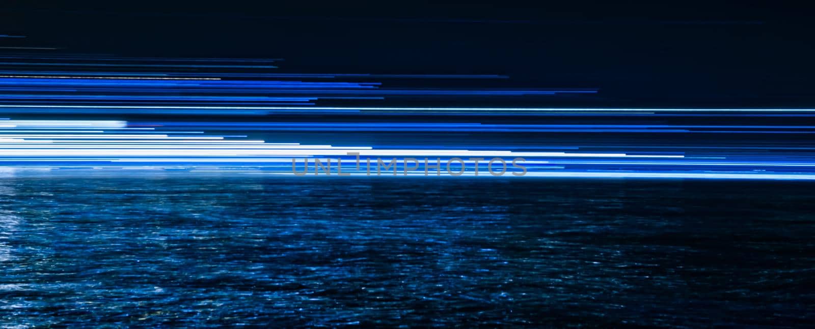 Abstract blue light trails reflected in the water