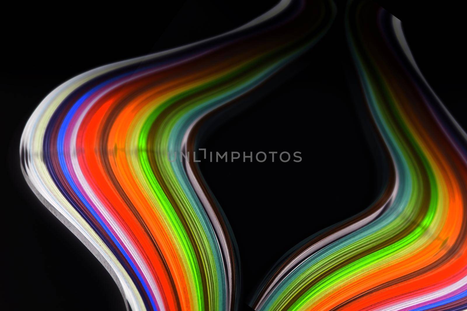 Abstract color wave curl rainbow strip paper on black background