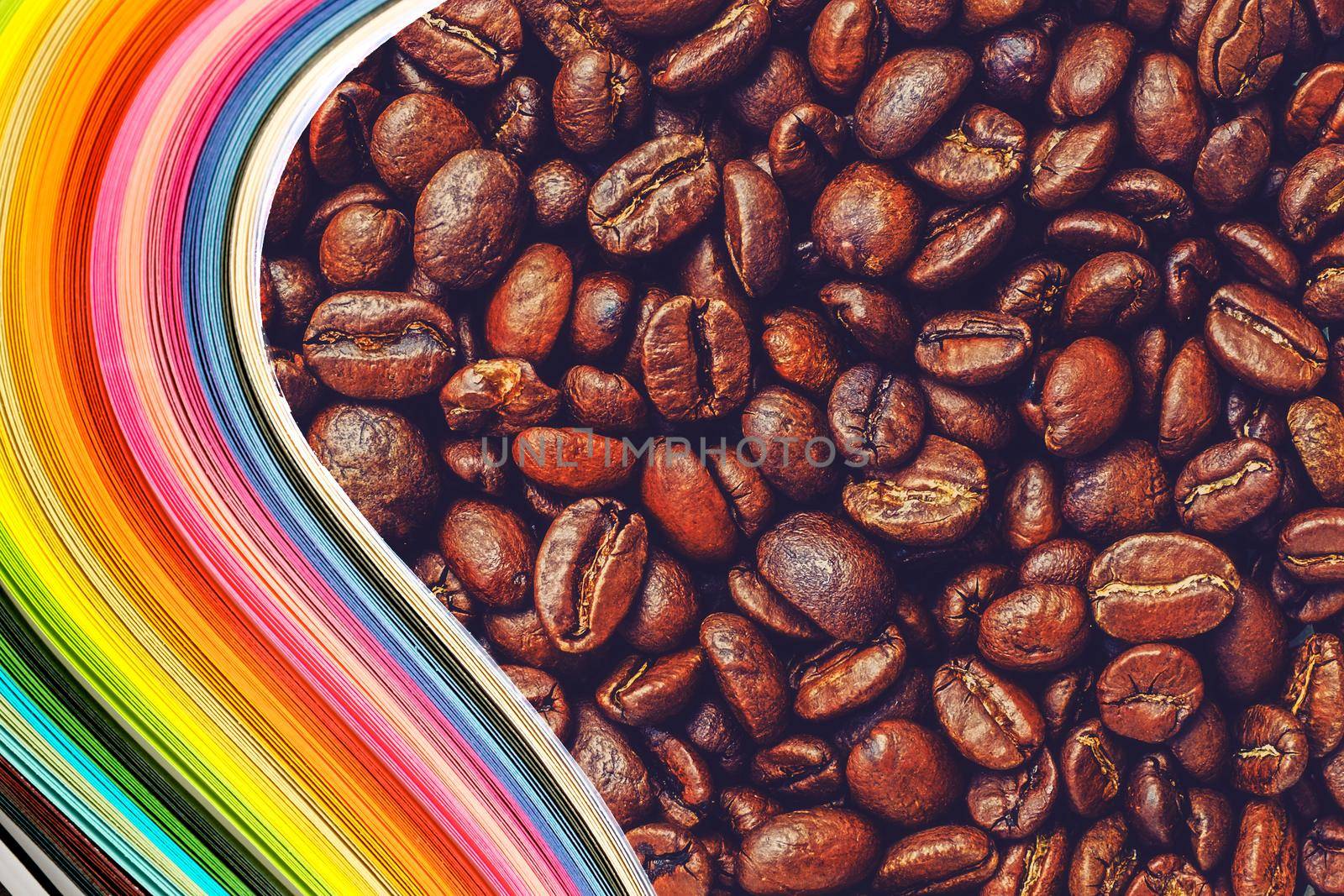 Abstract color wave curl rainbow strip paper on Roasted coffee beans background