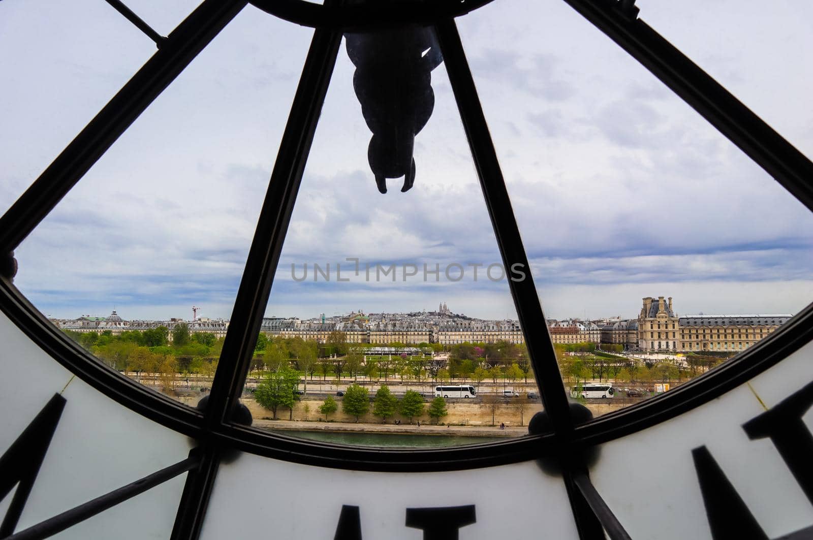 Paris cityscape, skyline view through the famous clock in the Orsay Museum. France. April 2019 by Olayola