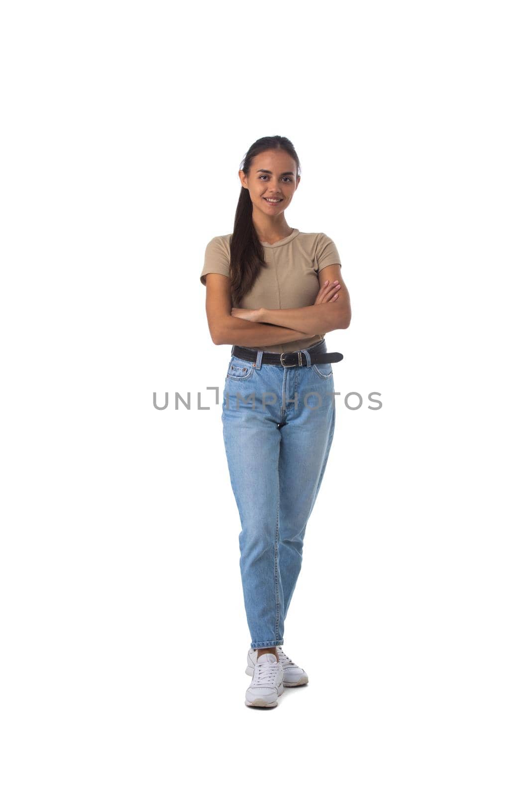 Full length portrait of casual latin girl standing with arms folded isolated on white background