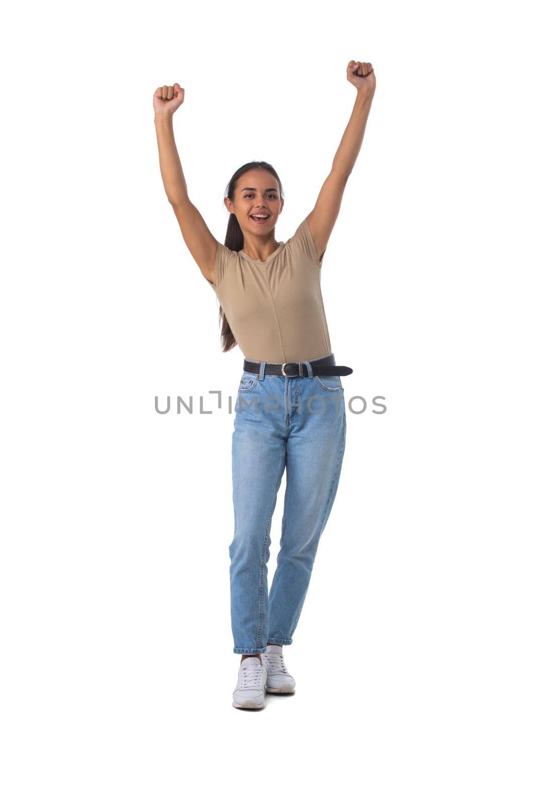 Casual girl standing with arms raised by ALotOfPeople