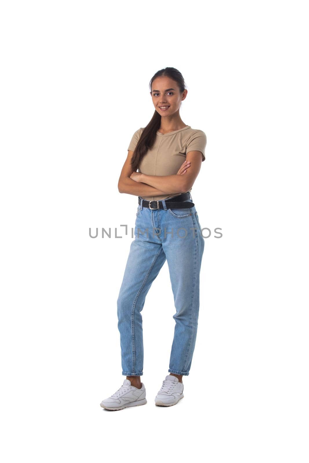 Full length portrait of casual latin girl standing with arms folded isolated on white background