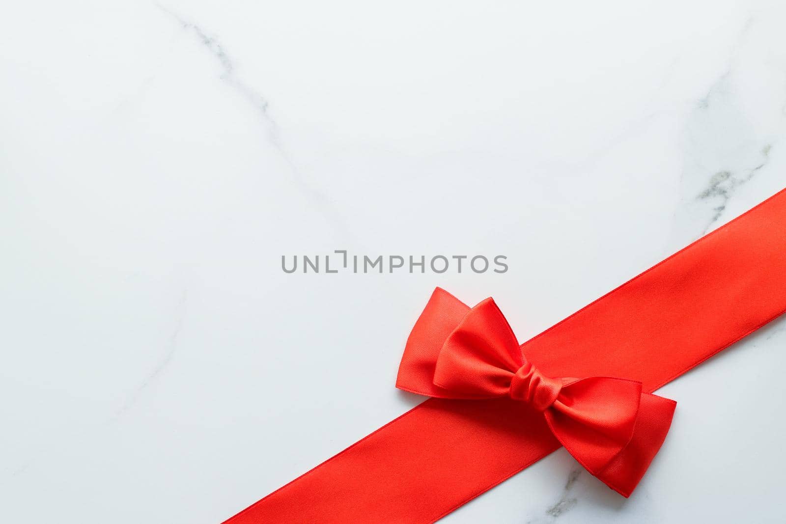 Holiday decor, feminine design and flatlay concept - Red silk ribbon on marble, top view