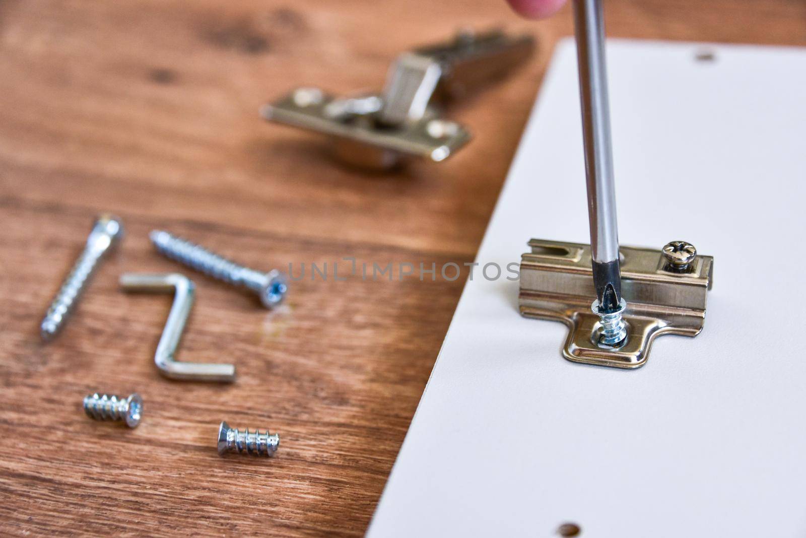 Assembly of cabinet furniture. screwdriver, screws, furniture fittings, door hinges. self-assembly of furniture.