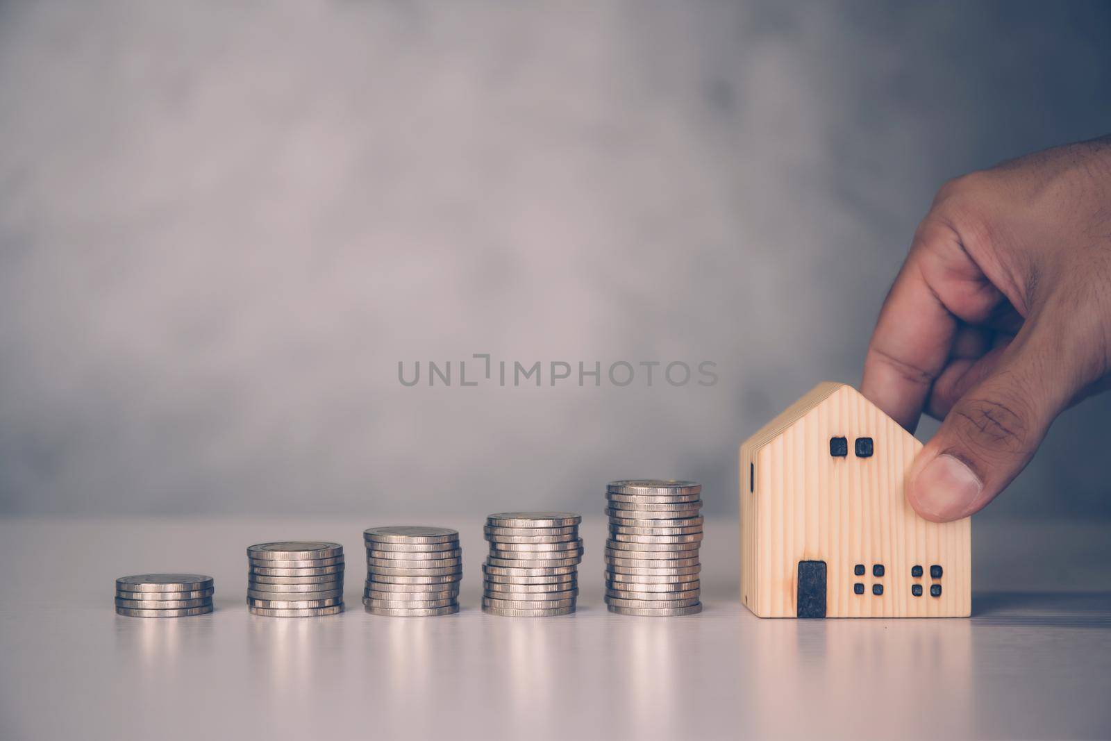 Hands of businessman and stack of coin with saving money for real estate and success, finance and investment, insurance home, deposit and property, residential and financial, business concept.