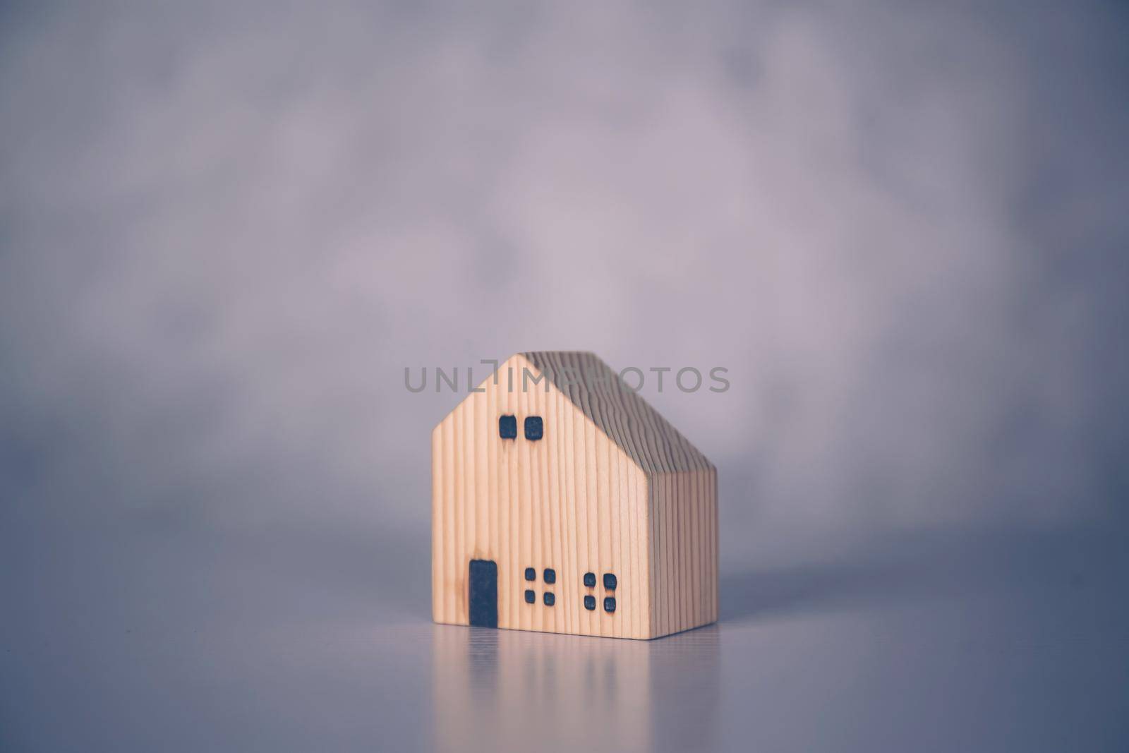 Mini wooden home model concept, investment of real estate and asset, tax of property and rental for finance, no people, small house and inspiration, mortgage and loan for residence, business concept. by nnudoo