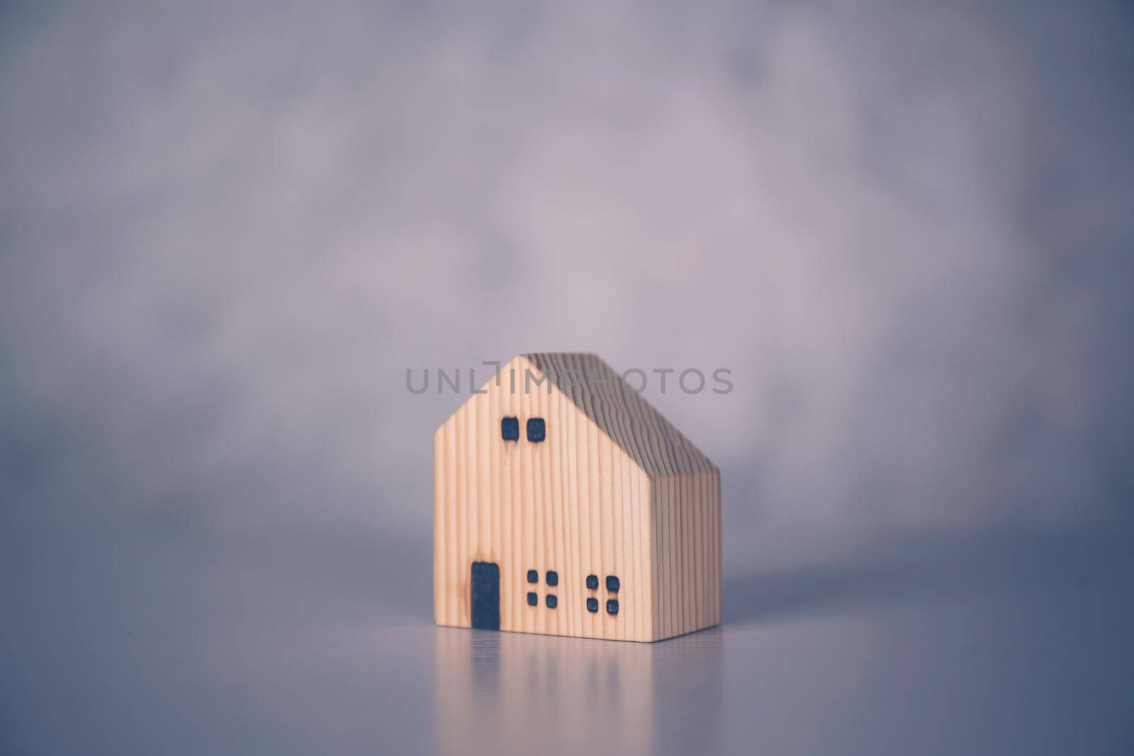 Mini wooden home model concept, investment of real estate and asset, tax of property and rental for finance, no people, small house and inspiration, mortgage and loan for residence, business concept.