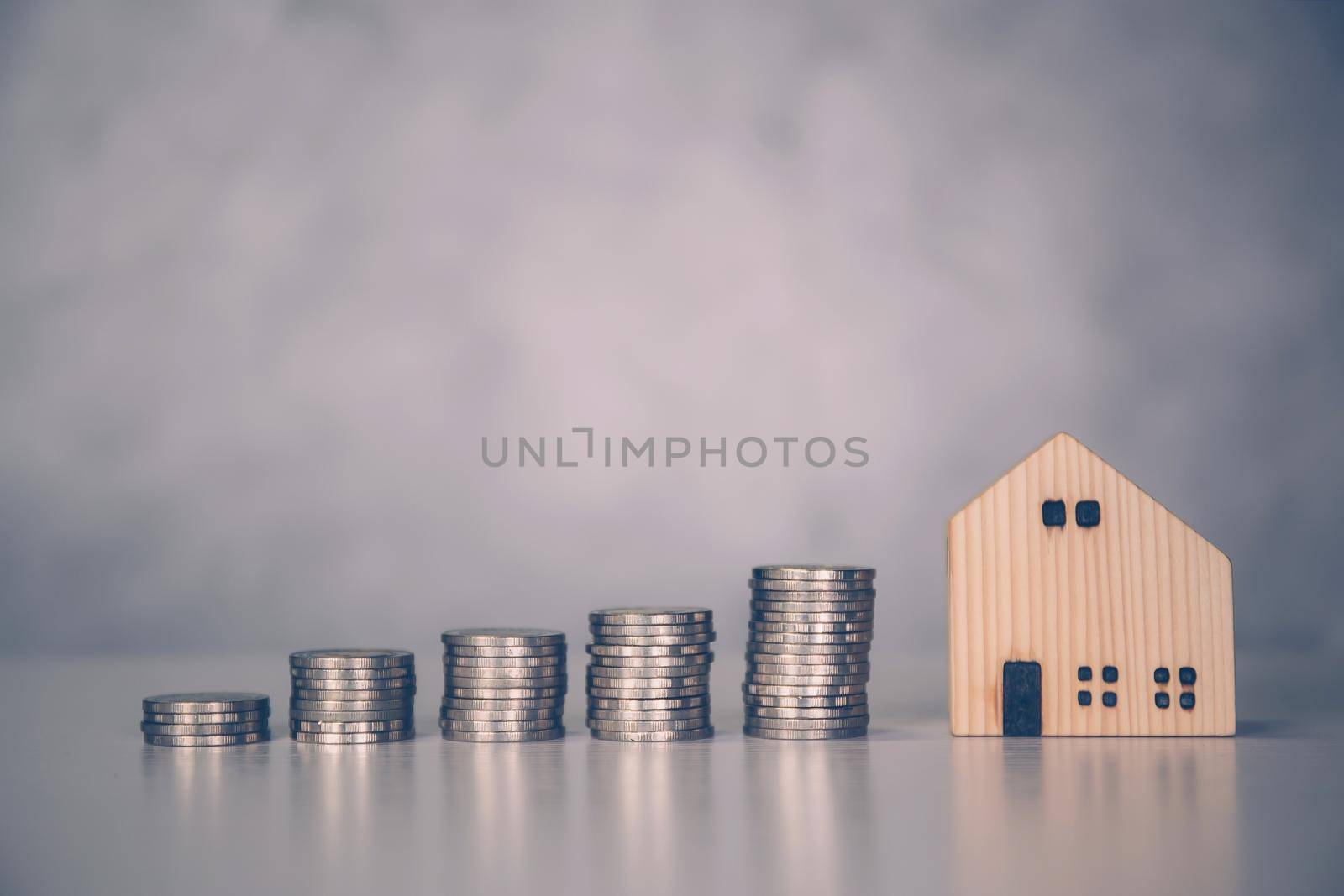 Stack of coin with revenue and saving money for real estate and success, finance and investment, insurance home, deposit and property and financial, residential and refinance, business concept.