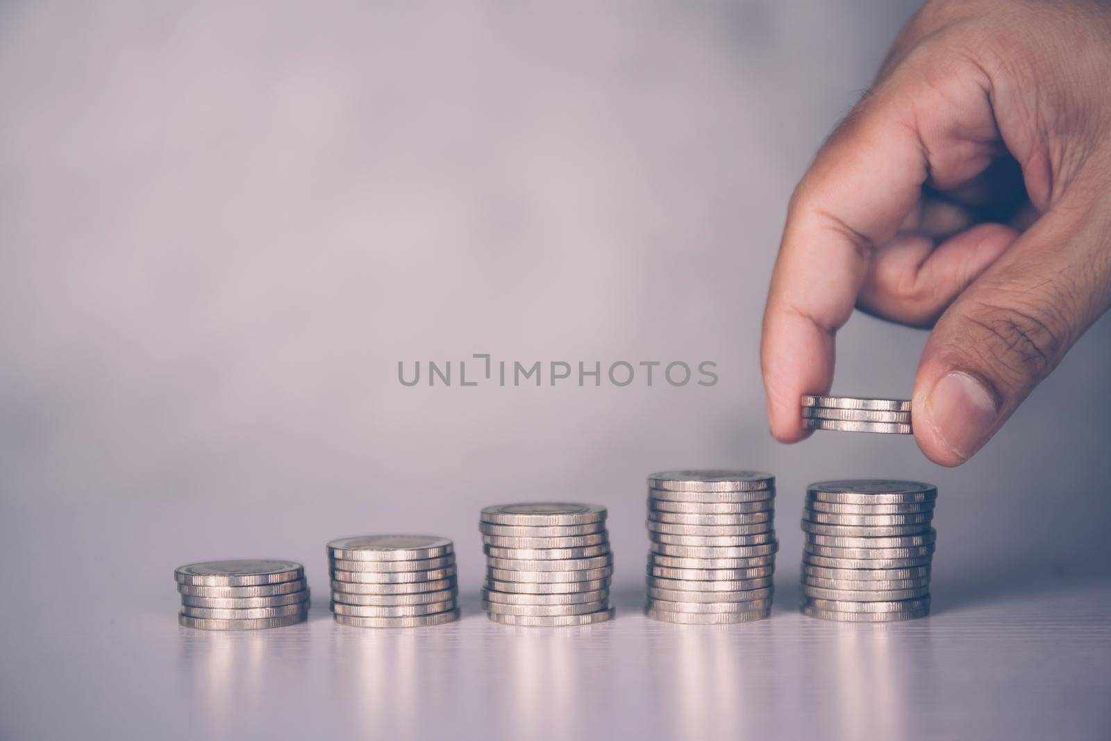 Hands of businessman put coin stack with increase growth, finance and saving, investment for profit and success, planning with financial, growing economy and fund, stock and income, business concept.