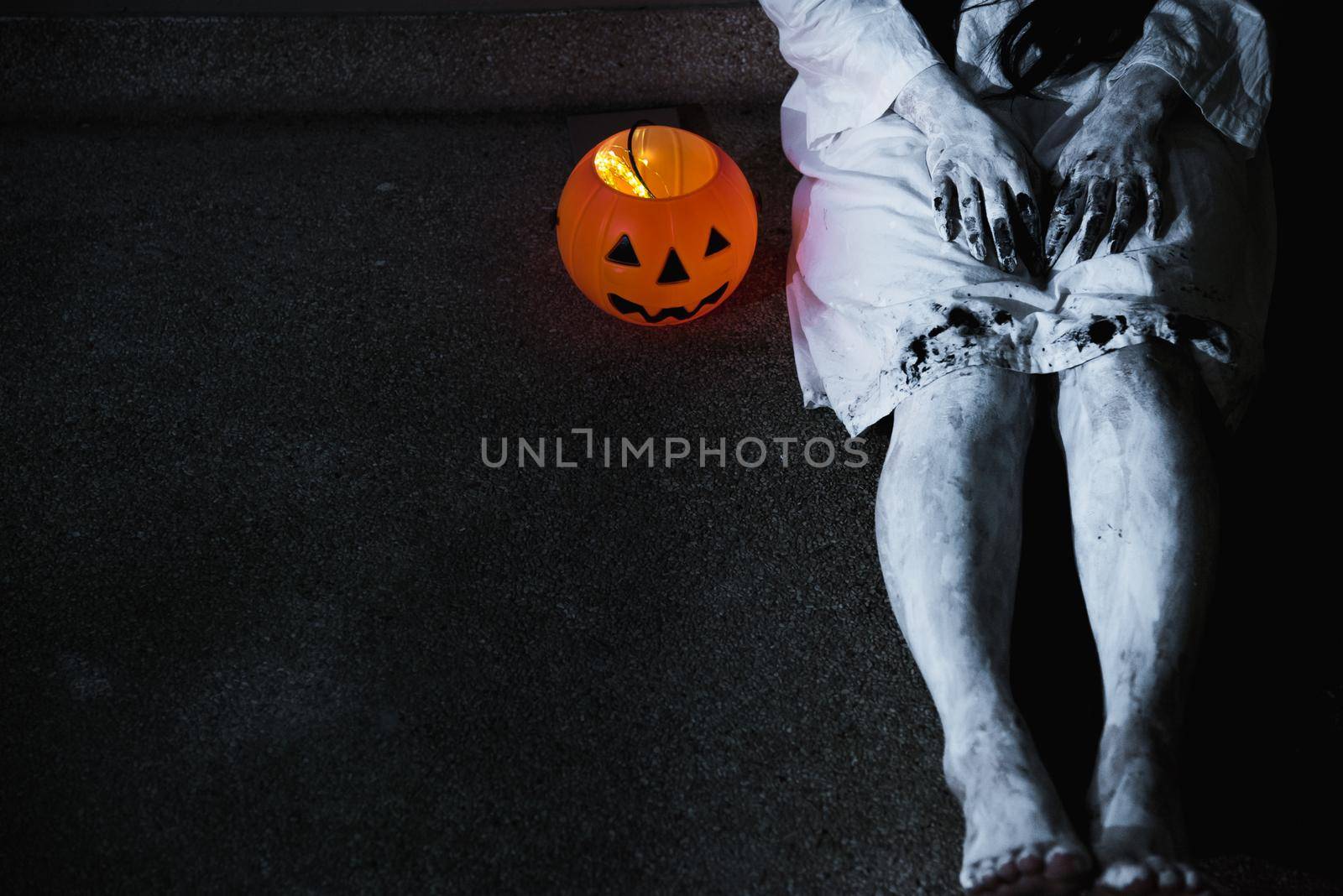 Woman ghost horror her have pumpkin beside body, halloween concept