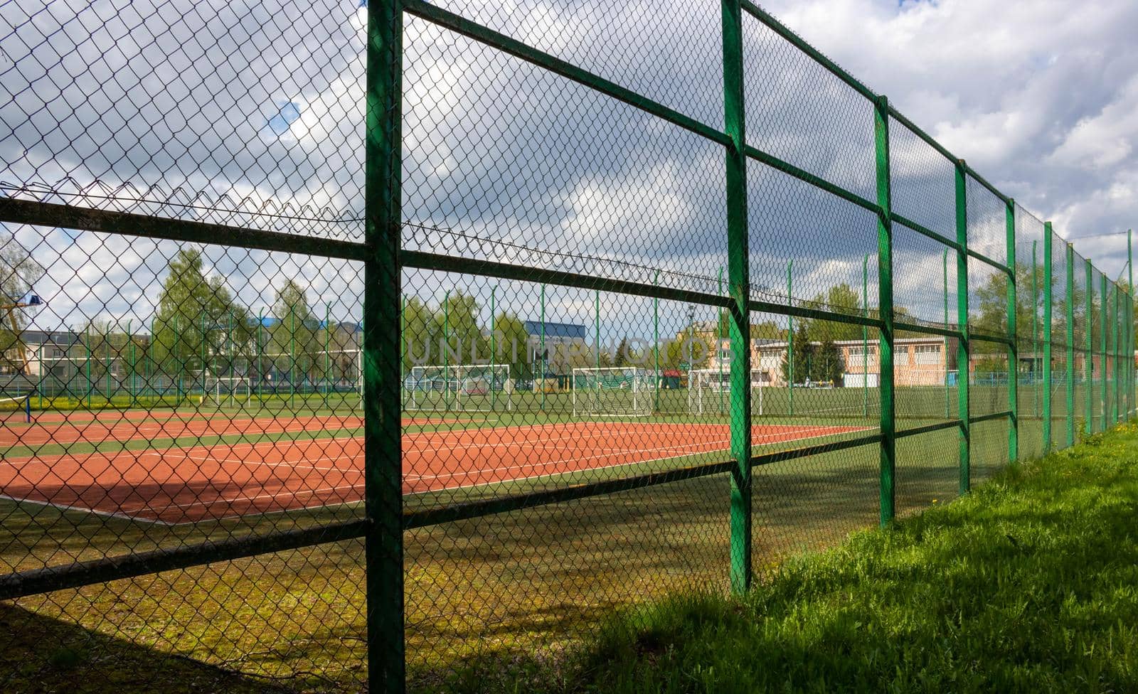 Tennis court at the open city stadium on a cloudy spring day by lapushka62