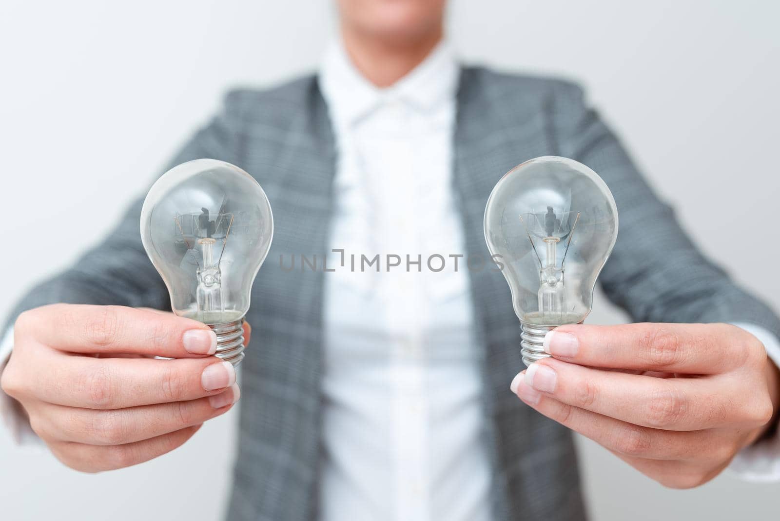 Lady Carrying Two Lightbulbs In Hands With Formal Outfit Presenting Another Ideas For Project, Business Woman Holding 2 Lamps Showing Late Technologies, Lighbulbexhibiting Fresh Openion.