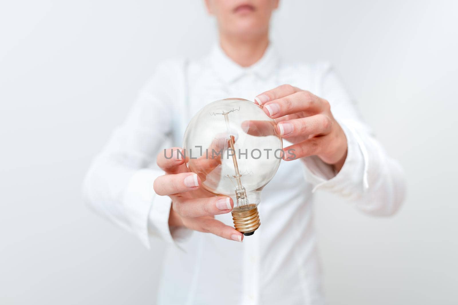 Lady Holding Lamp With Formal Outfit Presenting New Ideas For Project, Business Woman Showing Bulb With Two Hands Exhibiting New Technologies, Lightbulb Presenting Another Openion.