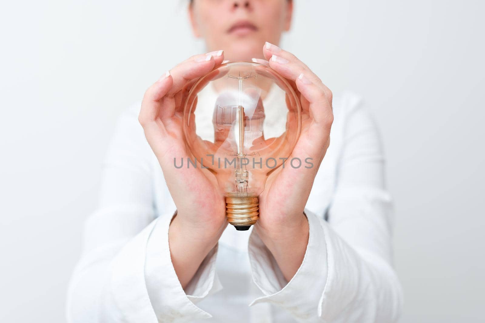 Lady Holding Lamp With Formal Outfit Presenting New Ideas For Project, Business Woman Showing Bulb With Two Hands Exhibiting New Technologies, Lightbulb Presenting Another Openion.