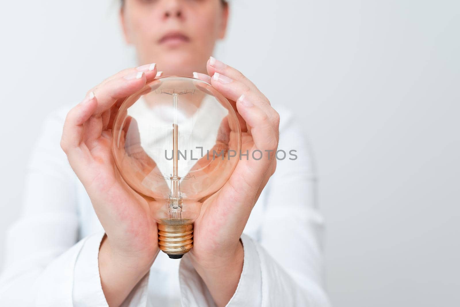 Lady Holding Lamp With Formal Outfit Presenting New Ideas For Project, Business Woman Showing Bulb With Two Hands Exhibiting New Technologies, Lightbulb Presenting Another Openion.