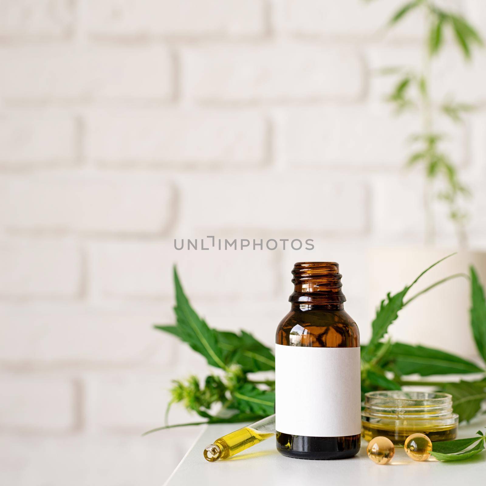 Alternative medicine, natural cosmetics. cbd oil and cannabis leaves cosmetics front view , copy space, mock up design