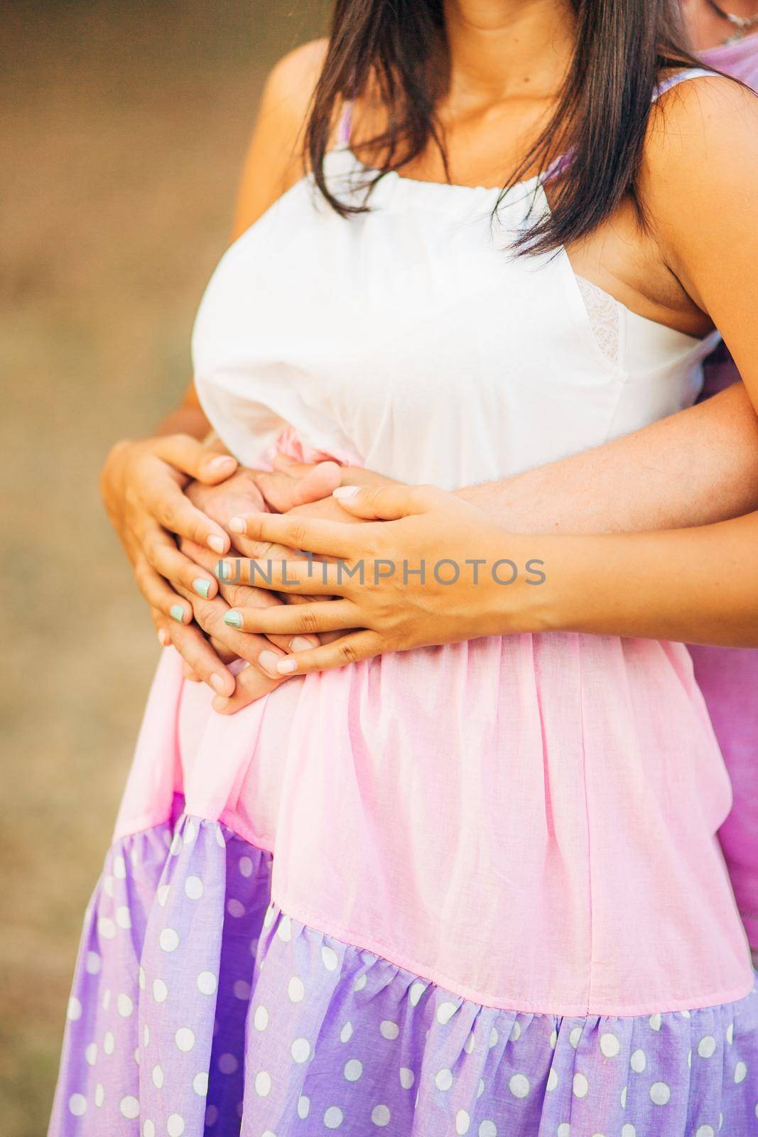 Pregnant woman holding belly with hands by Nadtochiy