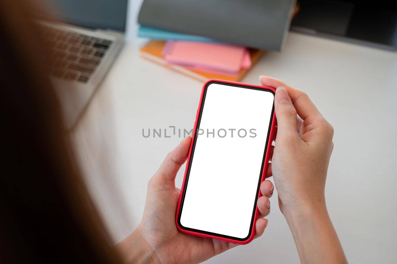 mock up phone in woman hand showing with blank copy space screen for your text message or information content, female reading text message on cell telephone