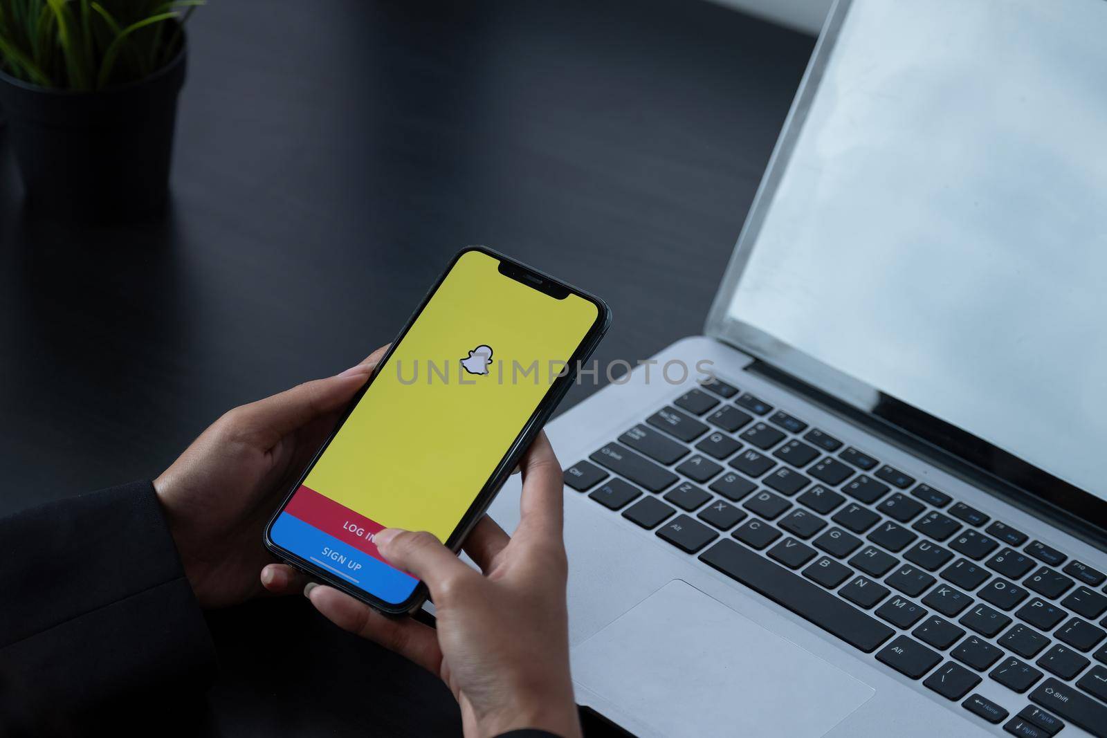 CHIANG MAI, THAILAND, APR 6, 2021 : Snapchat application icon on Apple iPhone X smartphone screen close-up in woman hands. Snapchat app icon. Social media icon. Social network