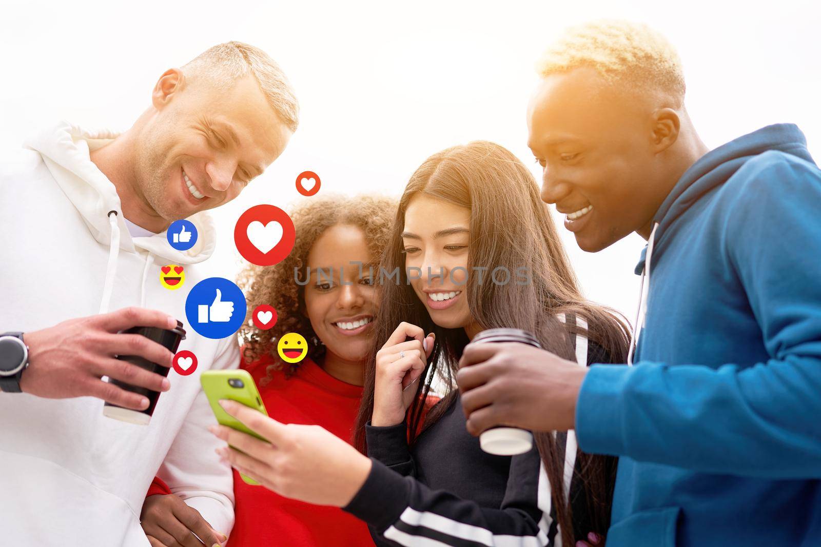 Multi-ethnic group teenage friends looking smartphone screen. African-american asian caucasian student spending time together Multiracial friendship Smiling People colorful sportswear drink coffee