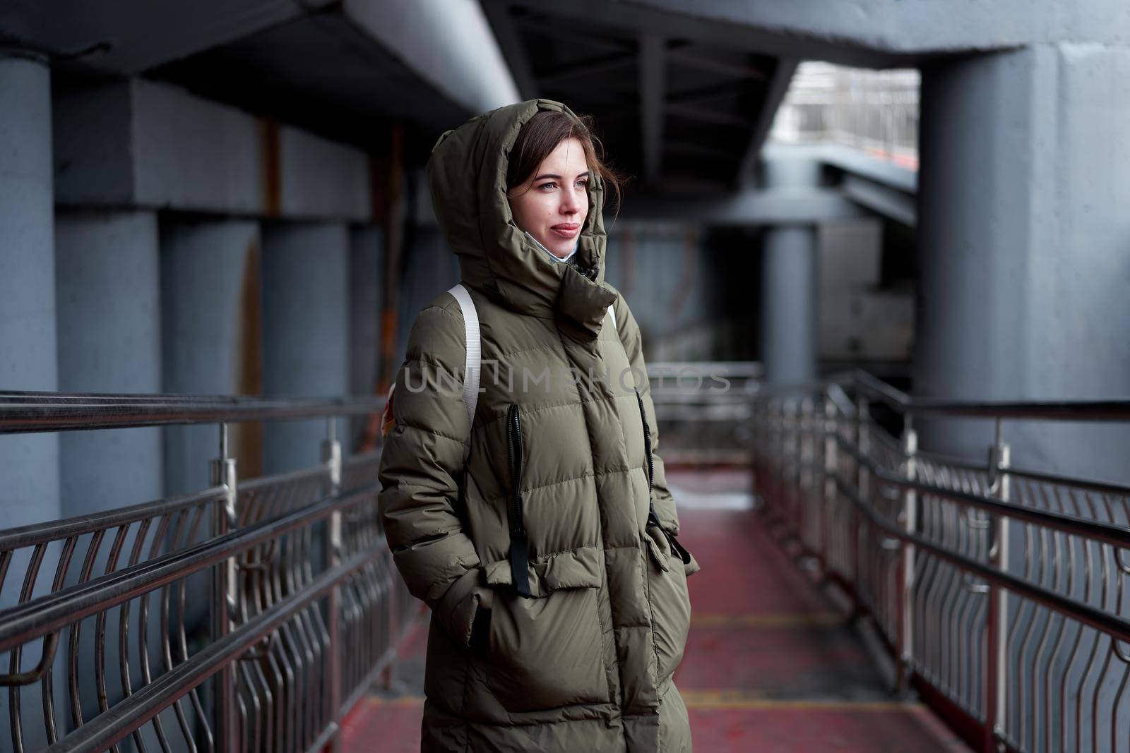 Woman portrait confidence brunette dressed warm winter jacket dark background dramatic atmosphere Caucasian female headshoot Women's parka