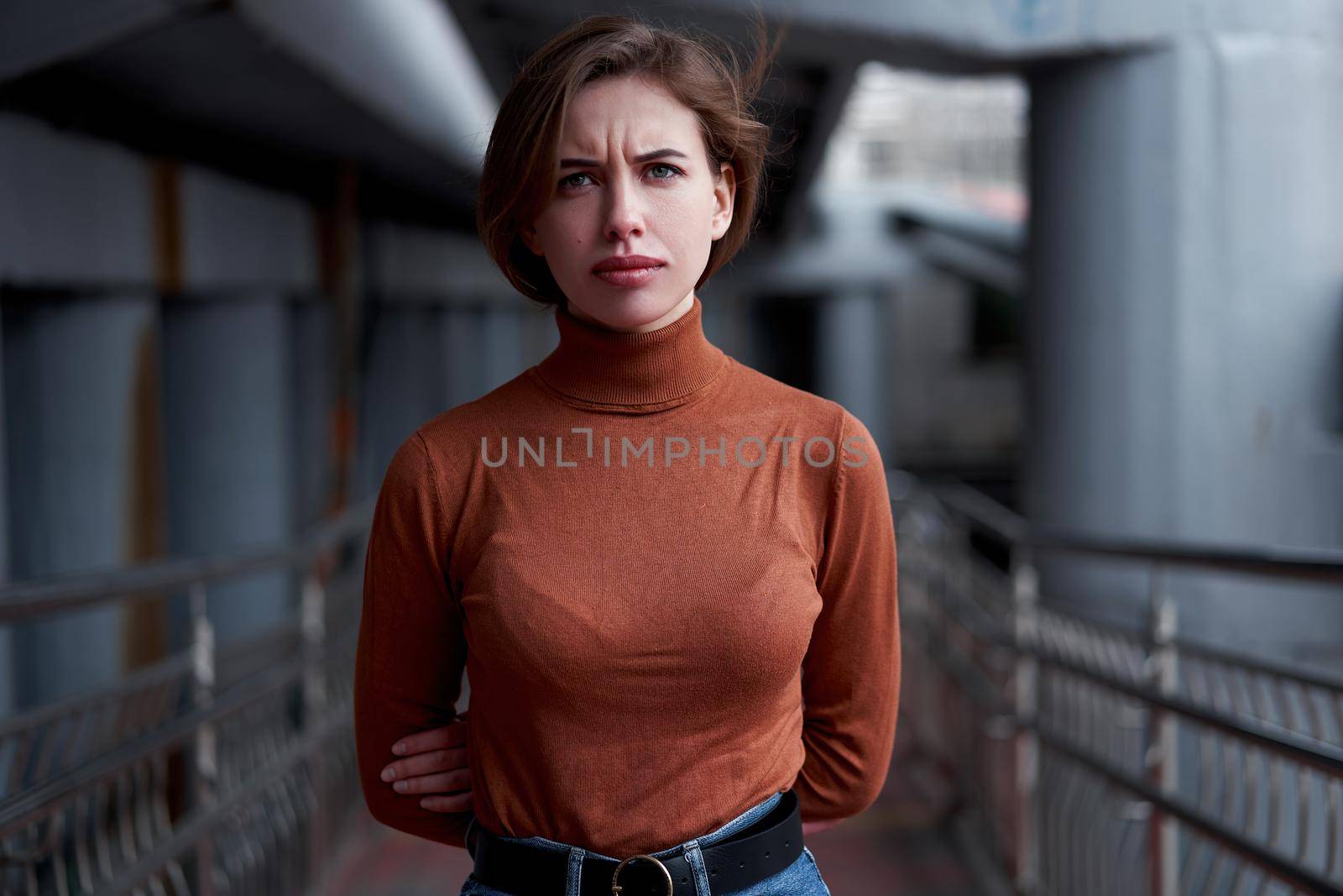 Woman portrait confidence brunette dressed brown turtleneck dark background dramatic atmosphere Caucasian female headshoot Women's golf sweater style