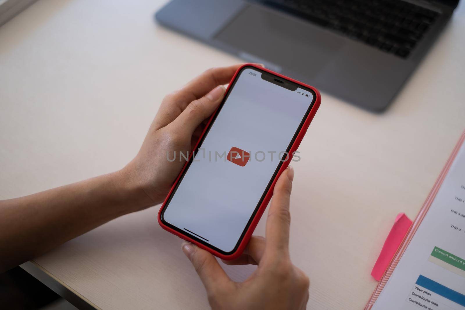 CHIANGMAI THAILAND - May 24,2021 : Apple iPhone with Youtube logo on the screen on wooden desk. by itchaznong