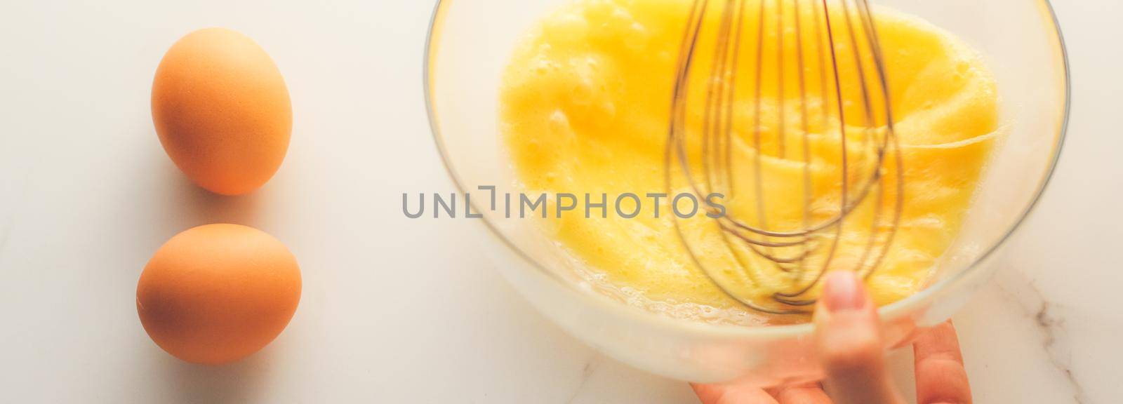 Cooking, meal and diet concept - Making of mixing eggs in bowl on marble table as homemade food flat lay, top view food brand photography flatlay and recipe for cooking blog, menu or cookbook design