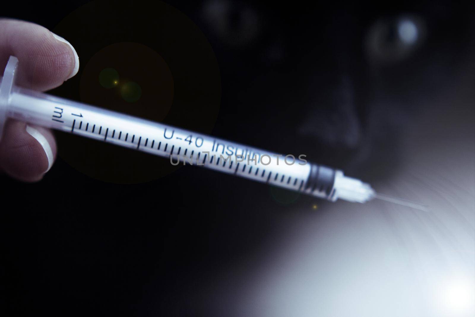 Insulin injecting syringe held by nurses hand. Copy space