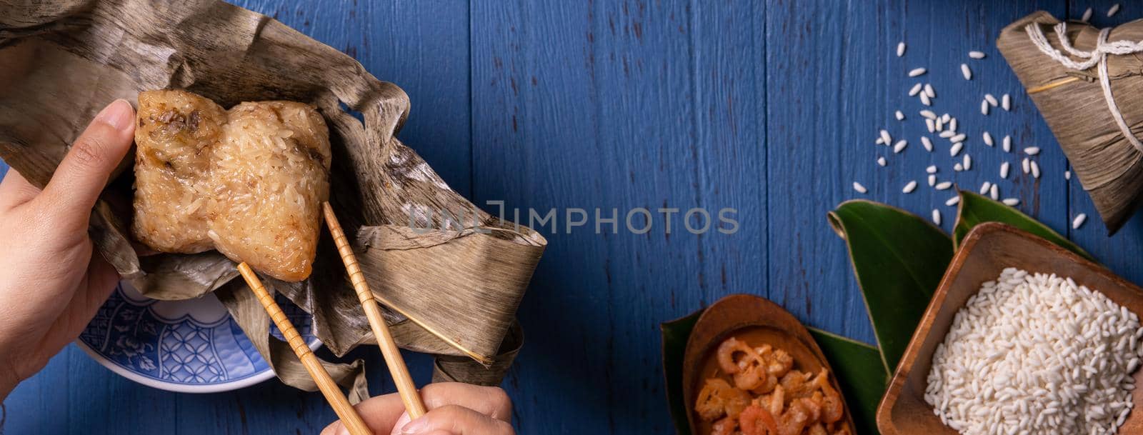 Zongzi rice dumpling with ingredients top view for Chinese traditional Dragon Boat Festival (Duanwu Festival) over blue wooden table background.