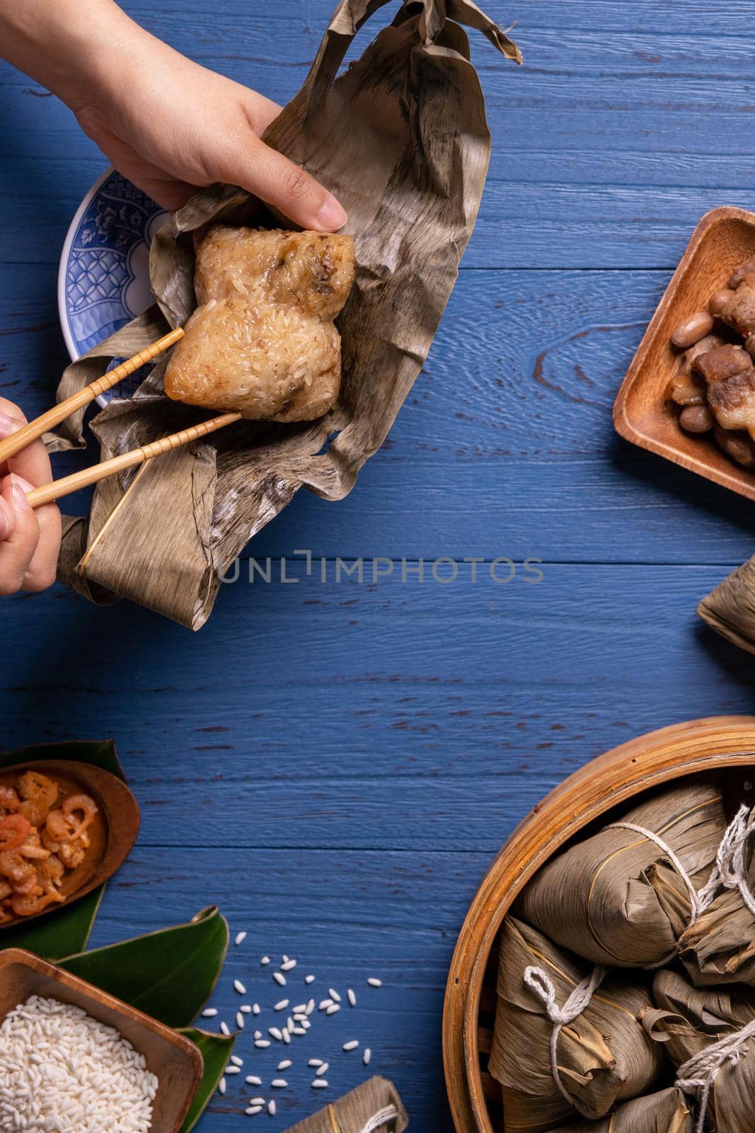 Zongzi rice dumpling with ingredients top view for Chinese traditional Dragon Boat Festival (Duanwu Festival) over blue wooden table background.