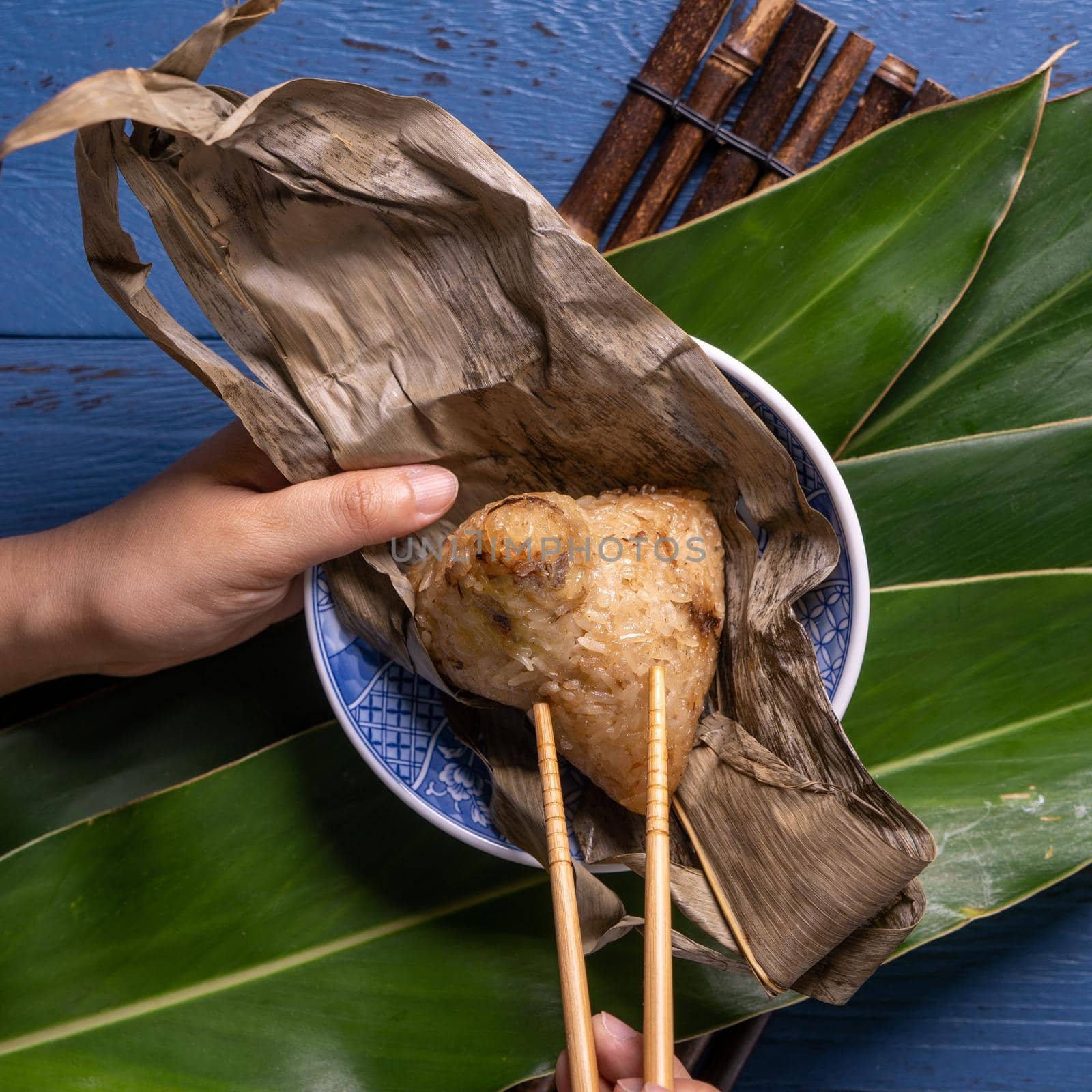 Zongzi rice dumpling with ingredients top view for Chinese traditional Dragon Boat Festival (Duanwu Festival) over blue wooden table background.
