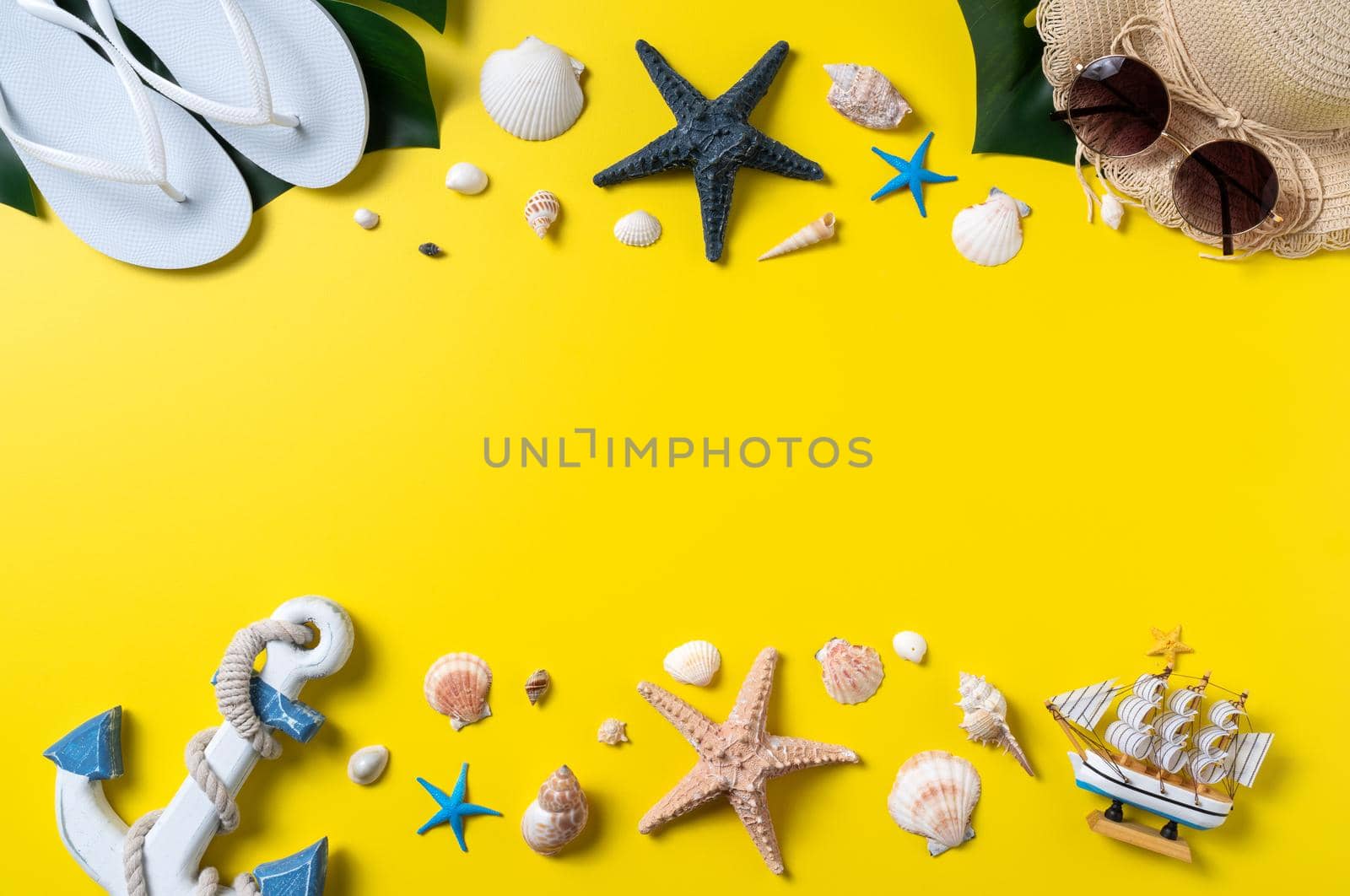 Summer beach design concept. Top view of holiday travel with shells, hat, slipper on yellow background.