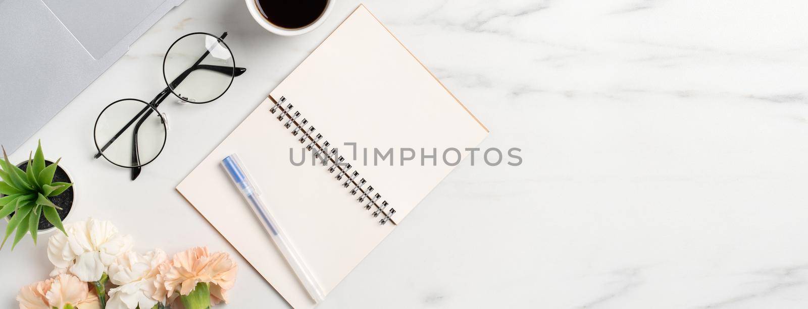 Mother's Day concept. Top view of greeting with carnation flower on mother's office table desk background.