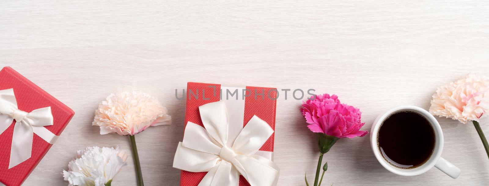 Mother's Day design concept. Top view of beautiful carnation flower and holiday gift idea with copy space.
