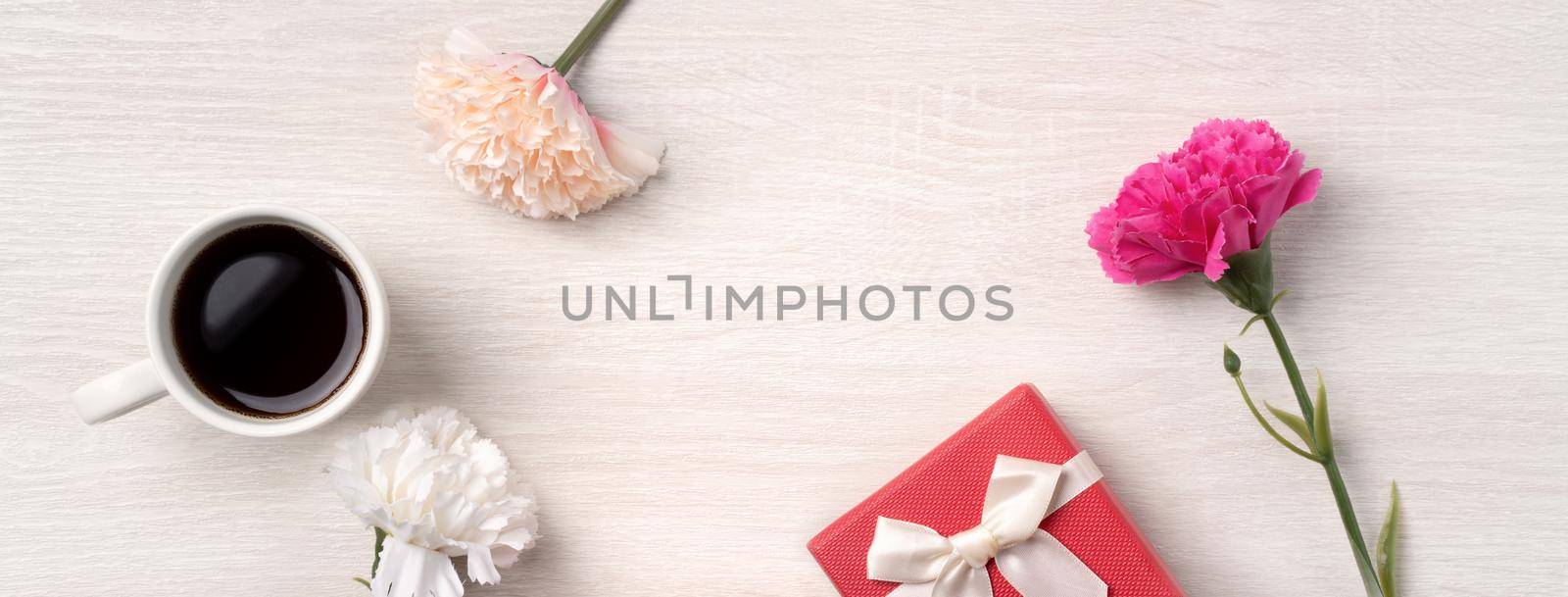 Mother's Day design concept. Top view of carnation flower and holiday gift idea. by ROMIXIMAGE