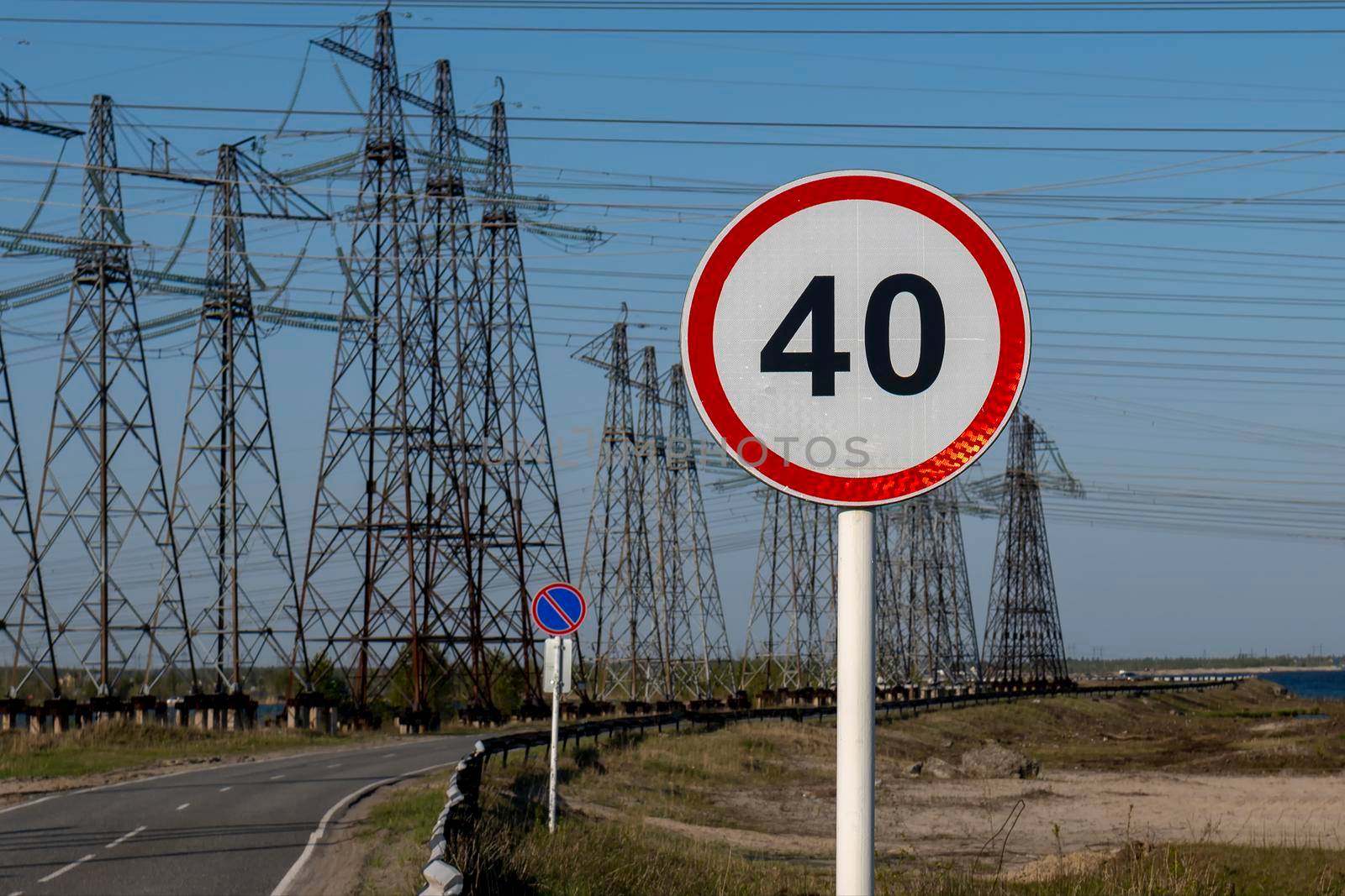 Road sign speed limit 40 km h against the background of the industrial landscape. by Essffes