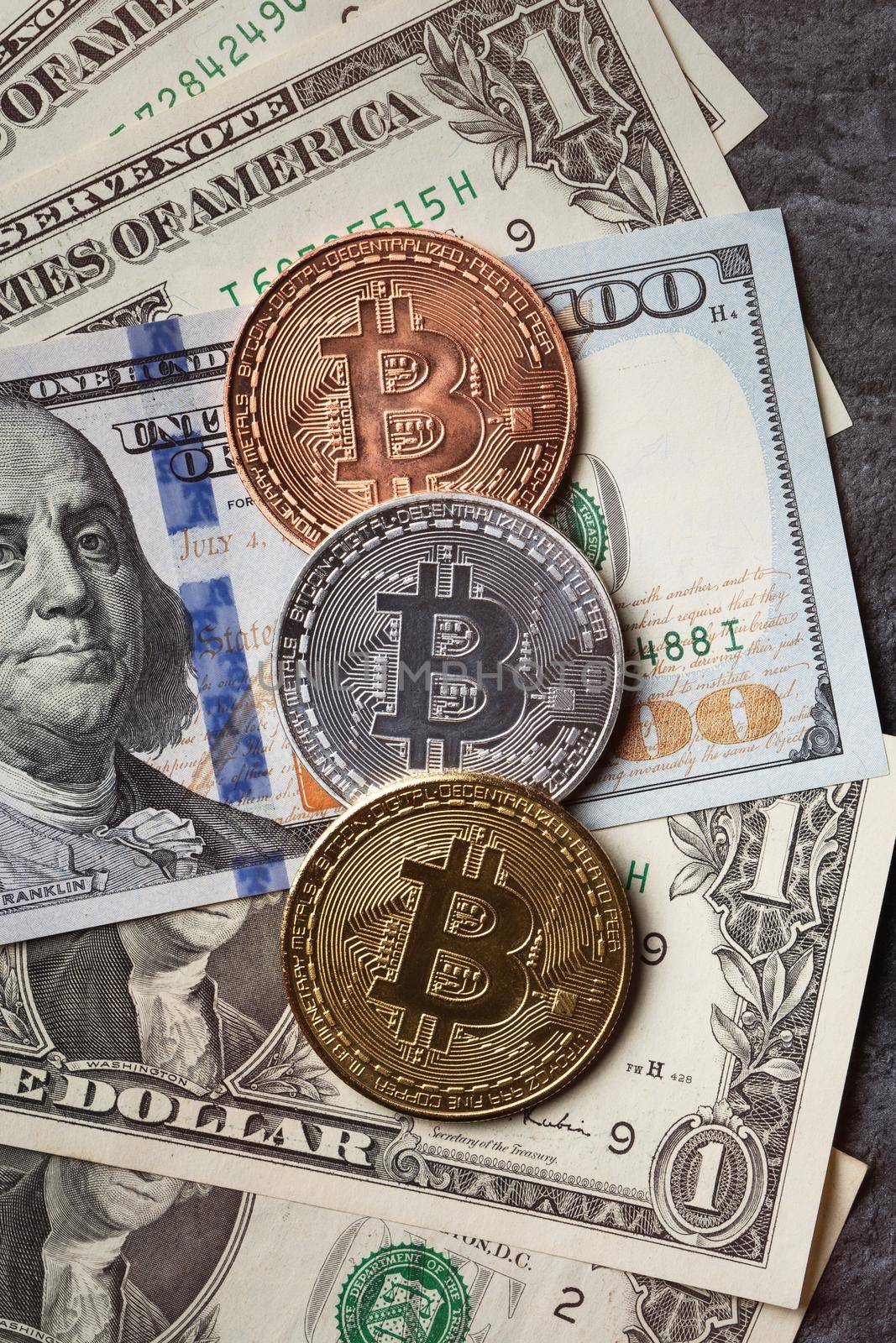 Business top view design concept of cryptocurrency bitcoin with USD Dollar paper currency money over dark black table background.