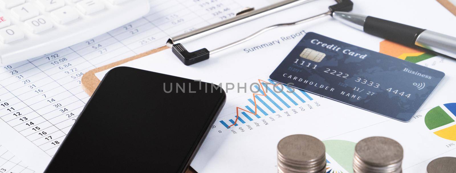 Design concept of annual summary analysis review report with calculator, paying with electronic device and credit card.