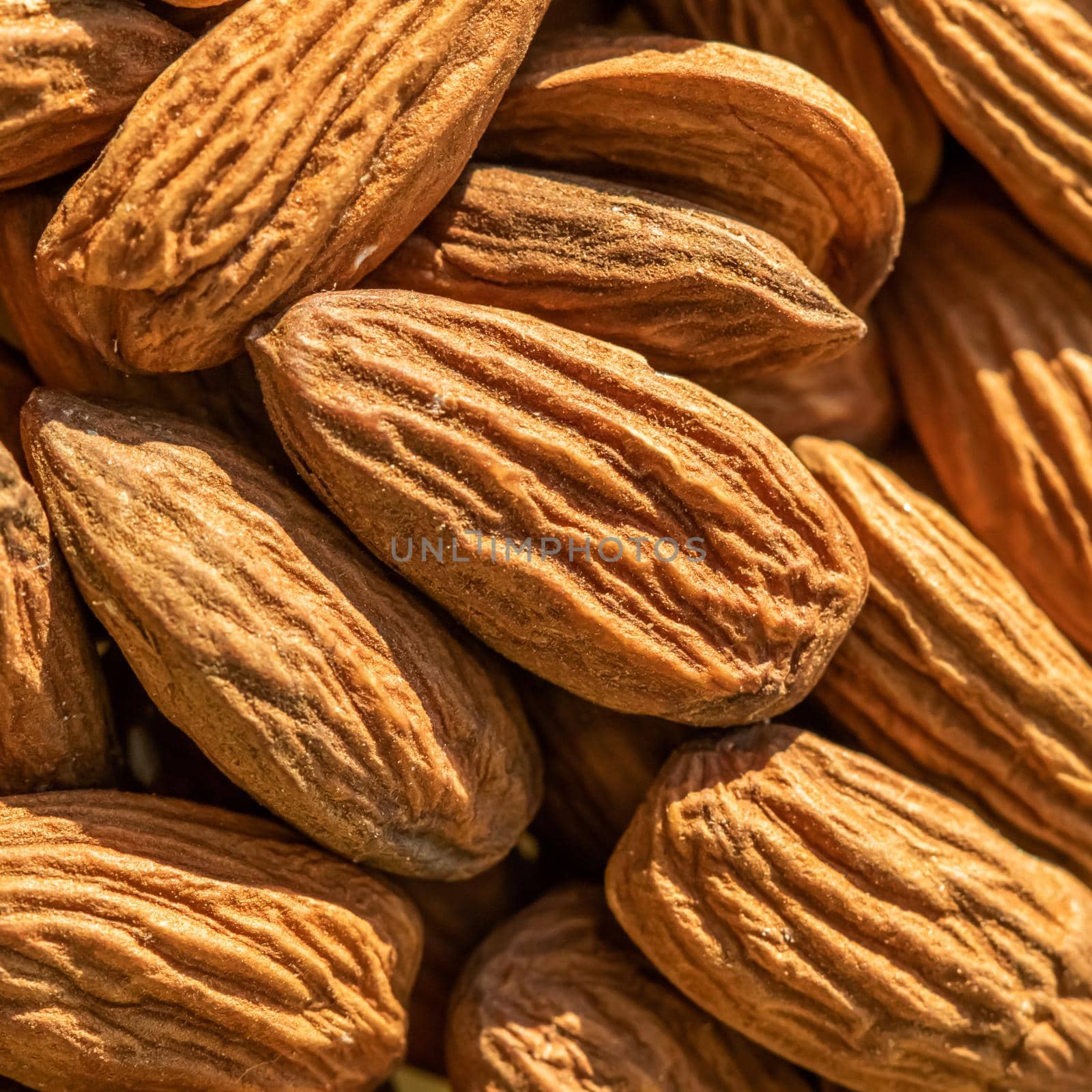 Big raw peeled almond nuts texture, top view. Almond nuts background.