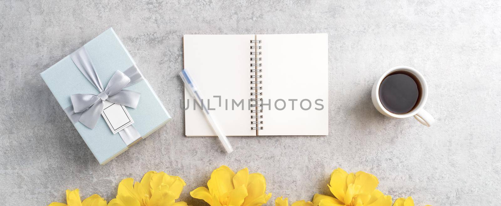 Concept of Mother's day holiday gift idea greeting design with yellow tulip flower bouquet on gray background