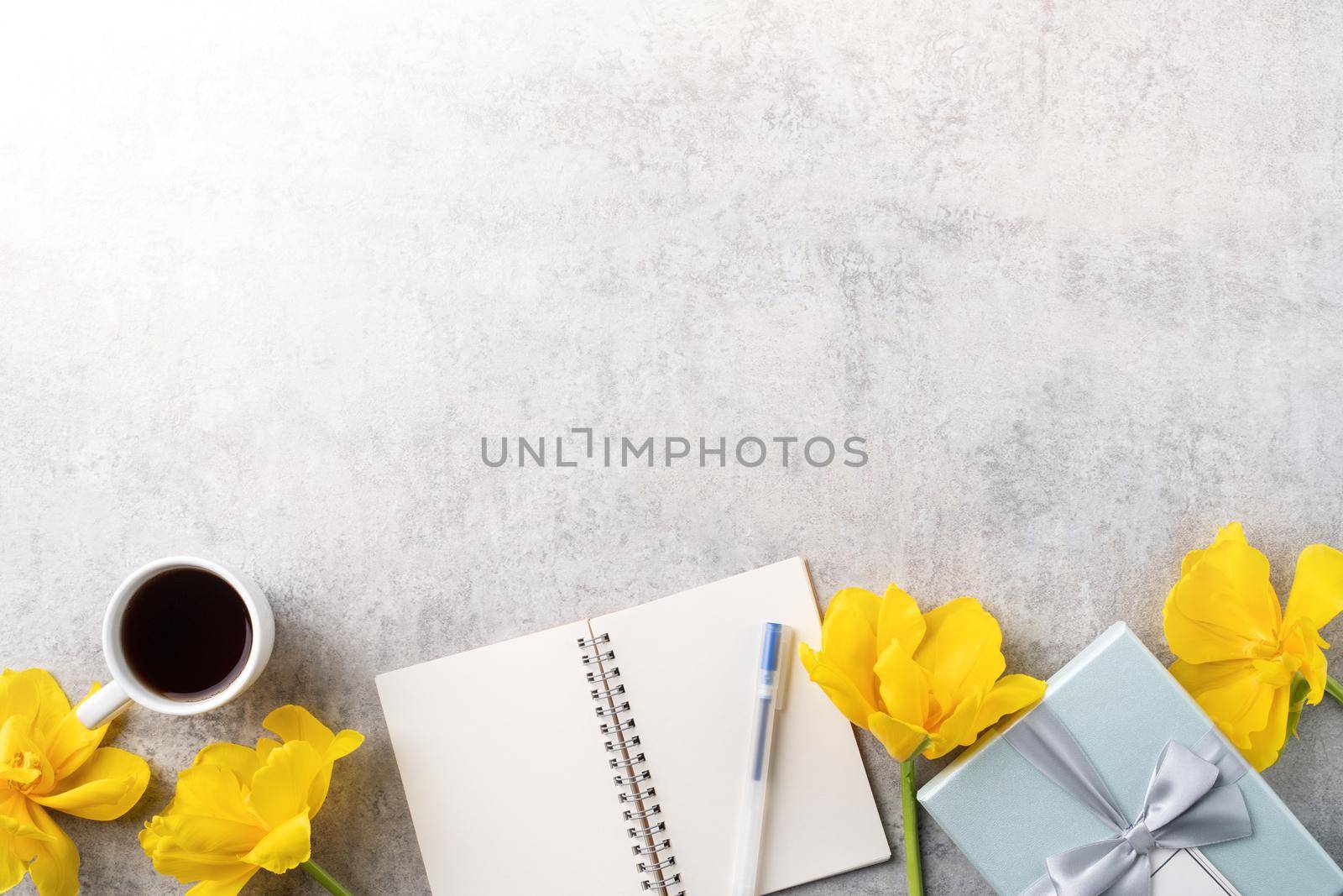 Concept of Mother's day holiday gift idea greeting design with yellow tulip flower bouquet on gray background