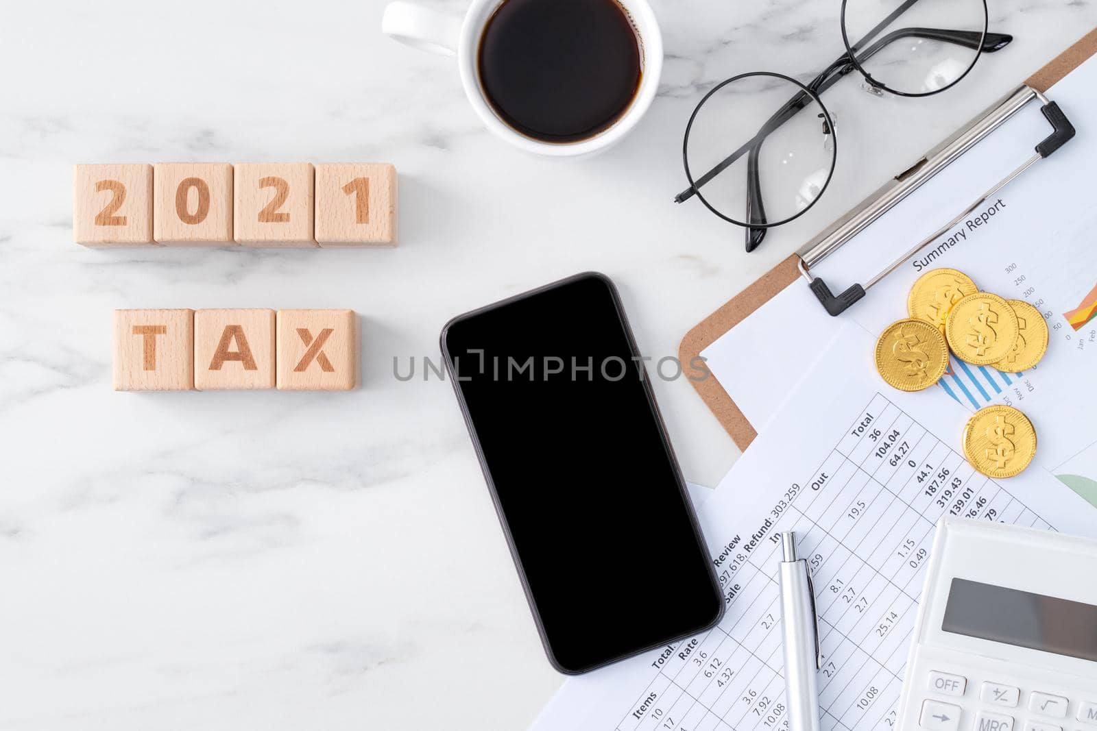 Top view of reading the overview and calculating, paying tax with smart phone from internet.