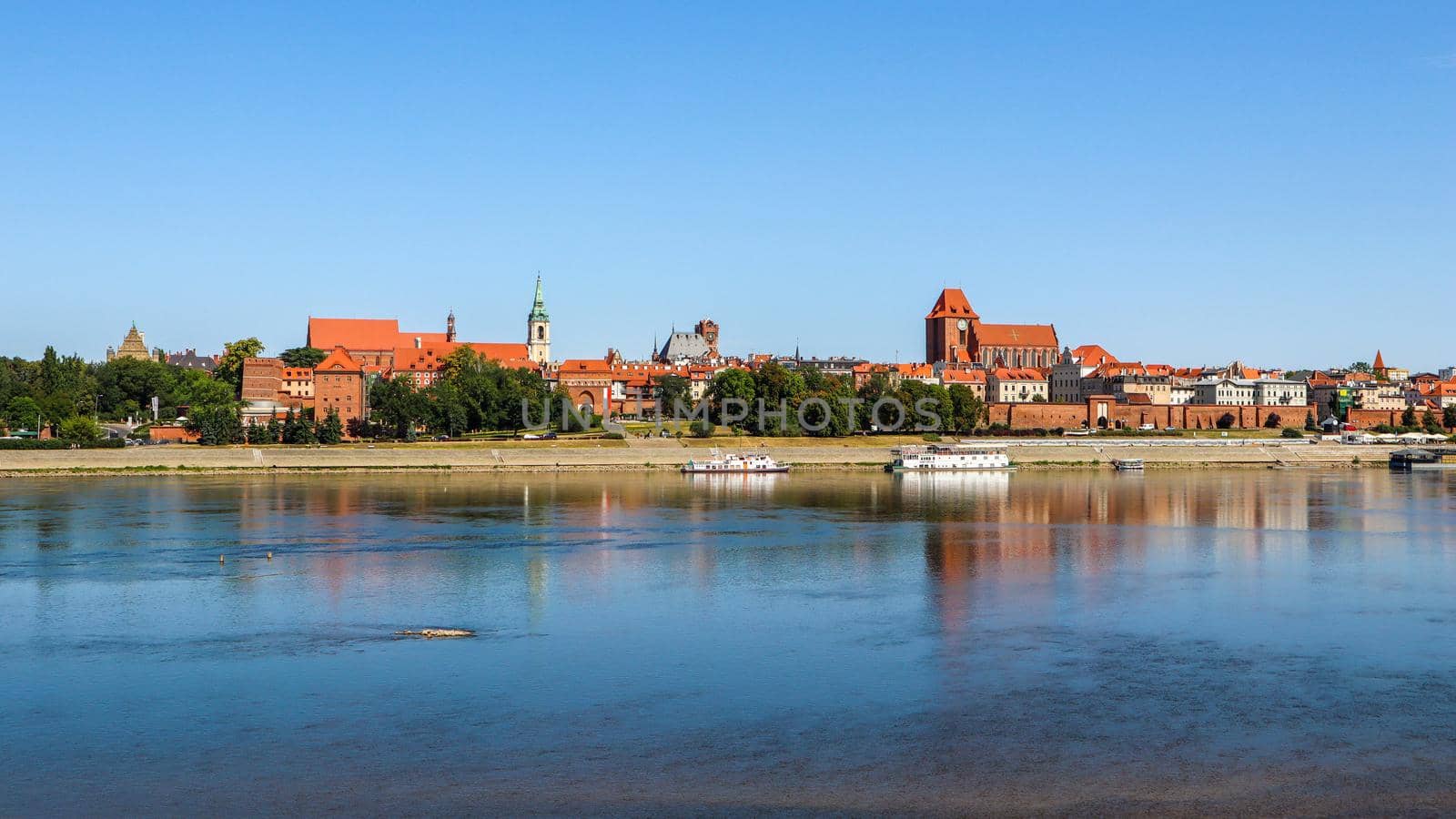 Panoramic view of Torun city and Wisla (Vistula) river in sunny day. Poland, summer 2019