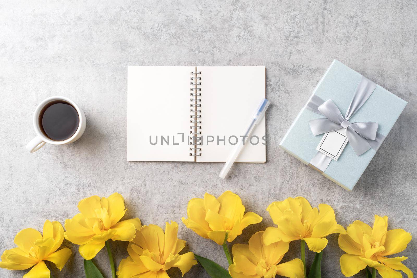 Concept of Mother's day holiday gift idea greeting design with yellow tulip flower bouquet on gray background