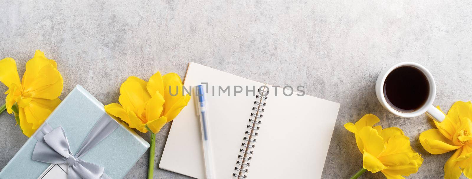 Concept of Mother's day holiday gift idea greeting design with yellow tulip flower bouquet on gray background