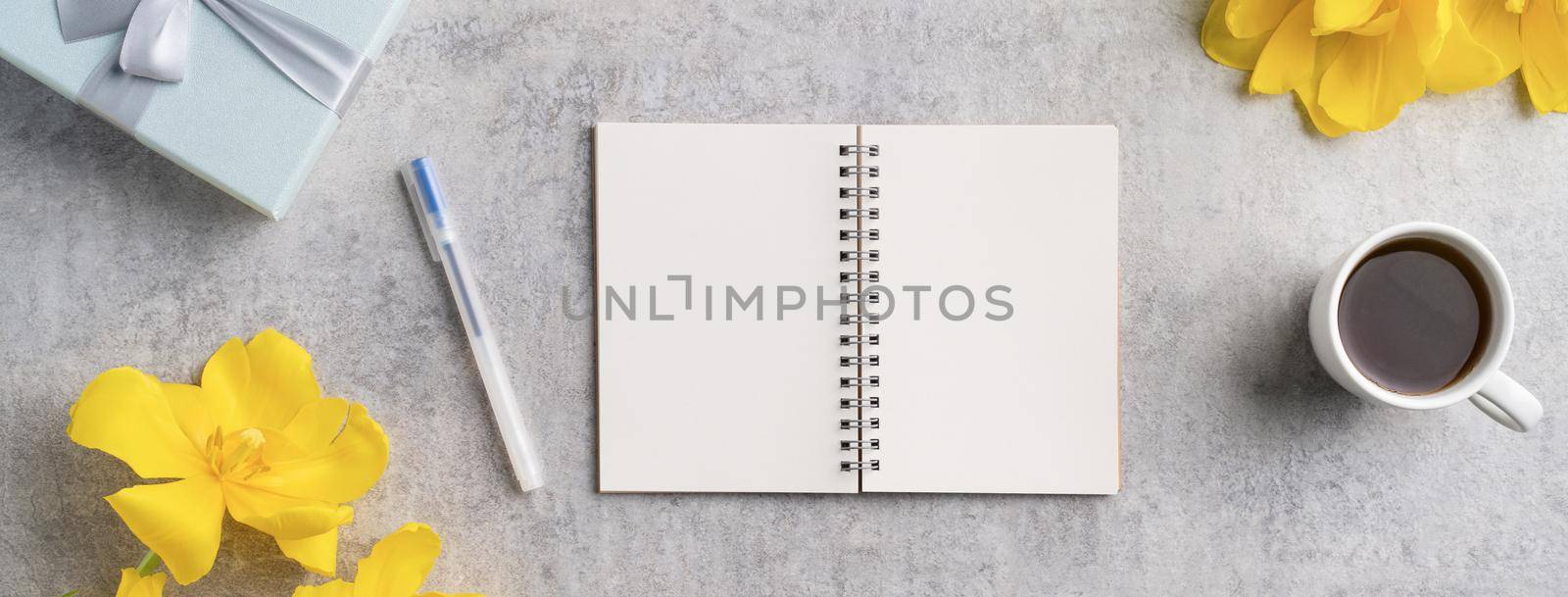 Concept of Mother's day holiday gift idea greeting design with yellow tulip flower bouquet on gray background