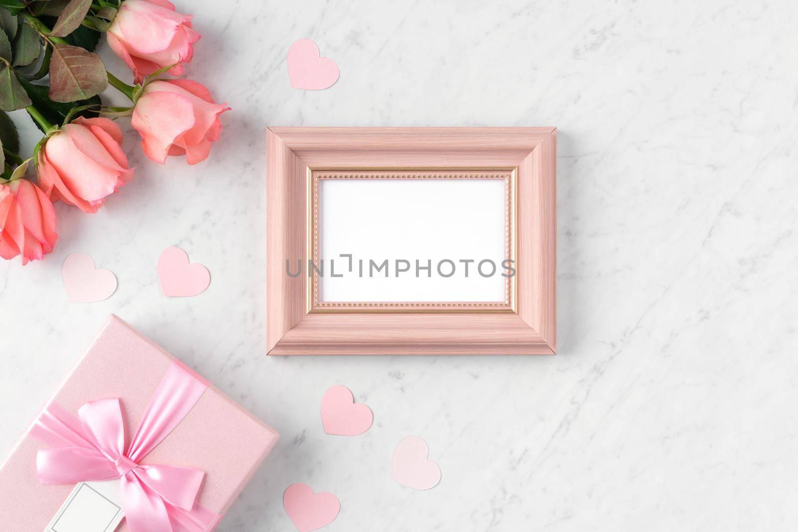 Giftbox and pink rose flower on marble white table background for Valentine's Day holiday greeting design concept.